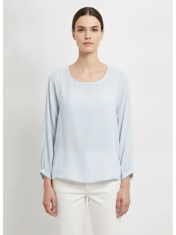 Hadley Blouse in Sky Blue, model shot on white